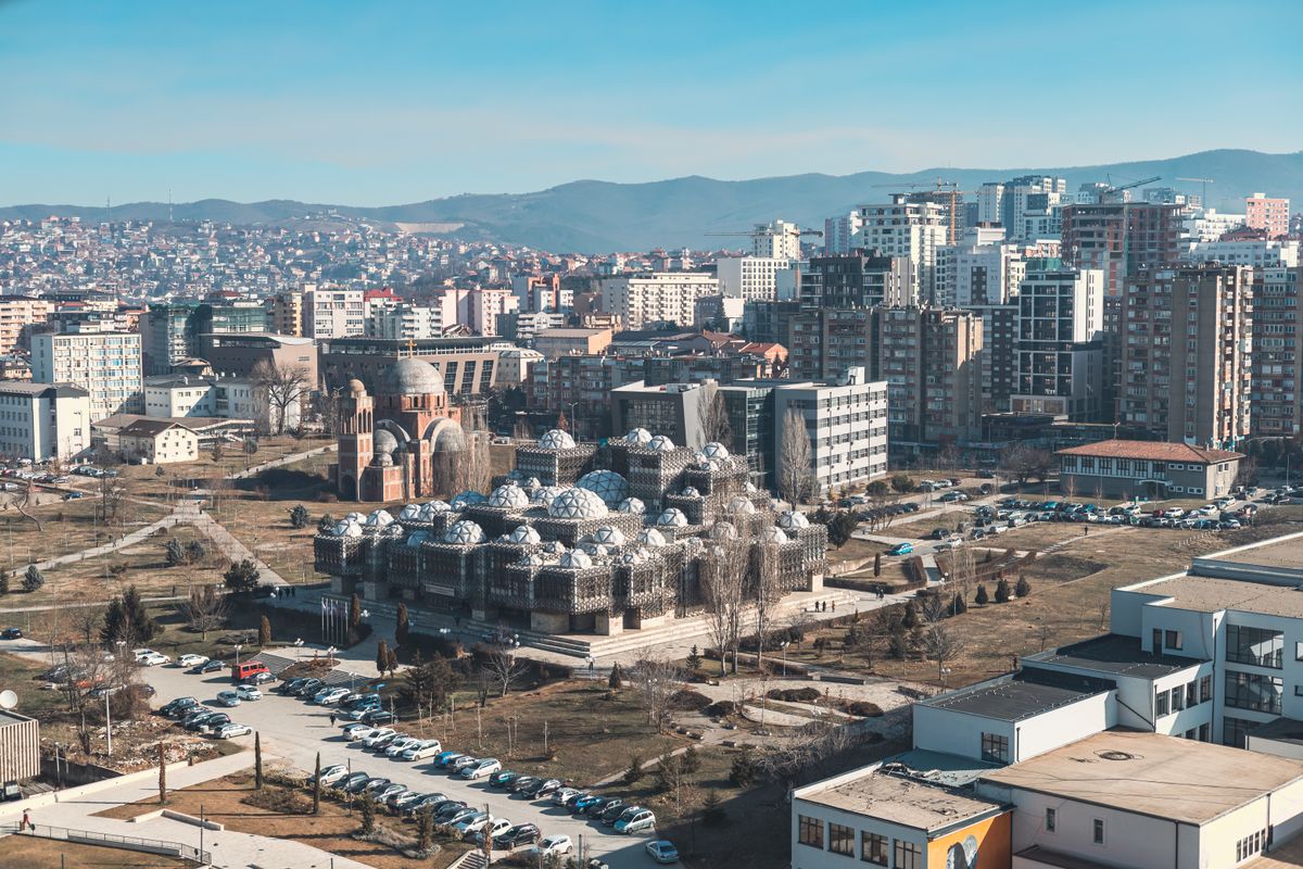 A panoramic view of Prishtina, featuring the National Library of Kosovo with its unique architecture.